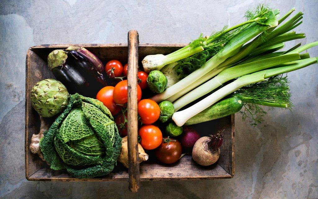 A Floreer team member with a basket of fresh local produce