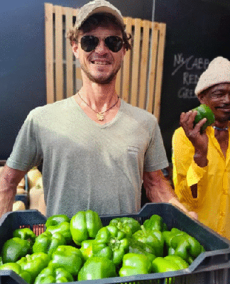 Local farmers with a crate of just-picked green peppers